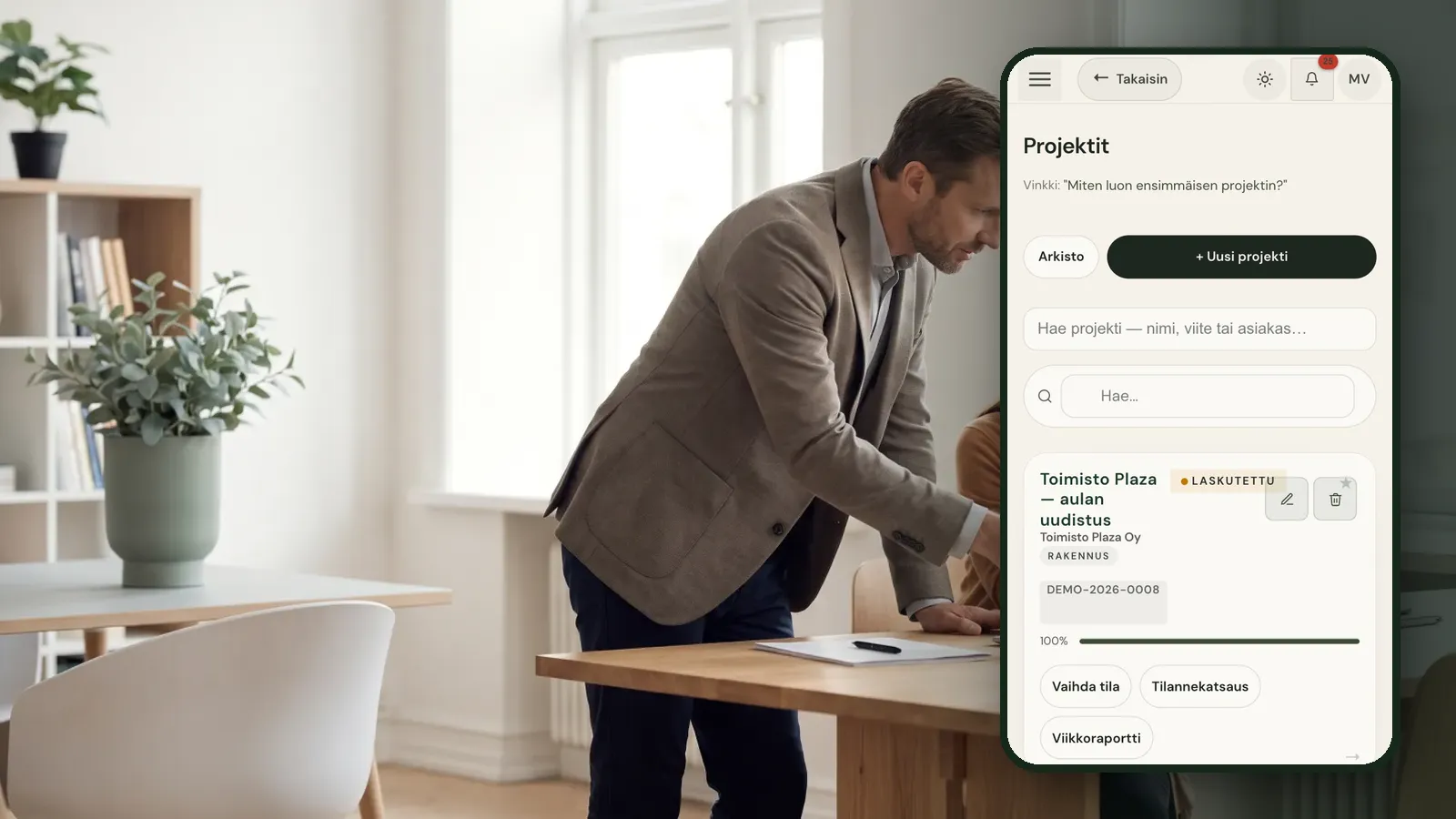 Consultant at a desk with a Raslak Hub view on a phone
